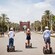 4 Guests on a Segway tour rolling down a path lined with palm trees